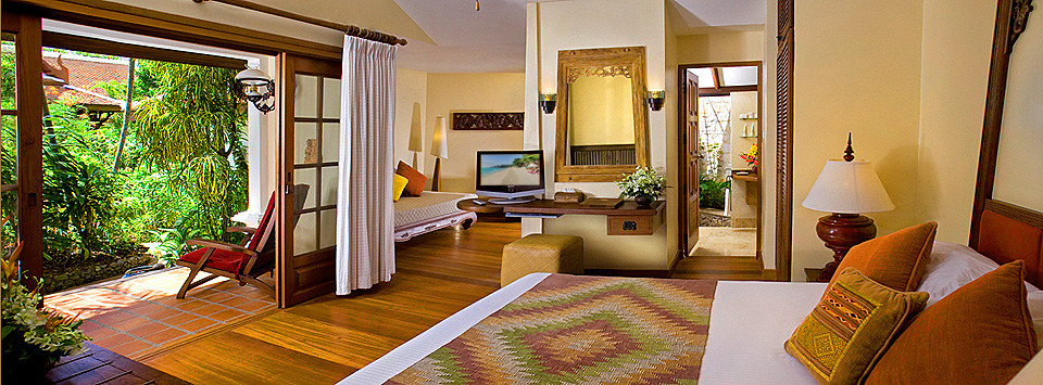 A cottage room at Poppies hotel showing bed and TV